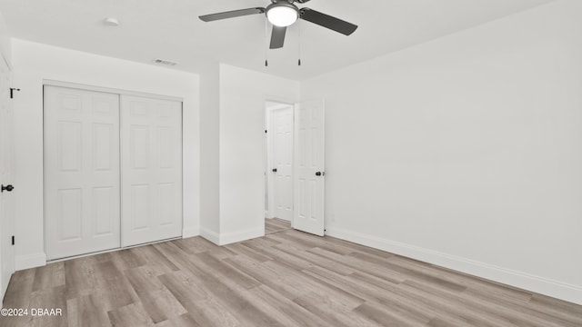 unfurnished bedroom featuring a closet, ceiling fan, and light hardwood / wood-style flooring