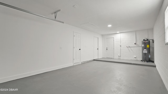 1801 James St, South Daytona, FL 32119 - garage with water heater, recessed lighting, and concrete block wall