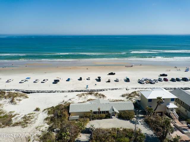 birds eye view of property featuring a water view and a view of the beach