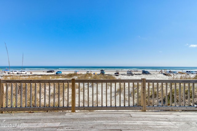 deck featuring a water view and a view of the beach