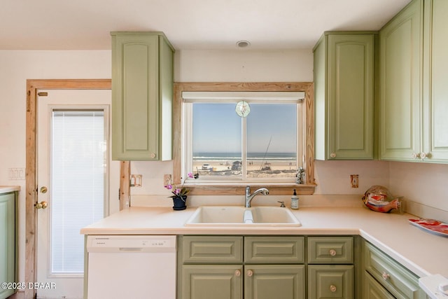 kitchen featuring a sink, green cabinetry, dishwasher, and light countertops