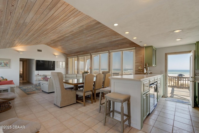 kitchen with vaulted ceiling, light countertops, visible vents, and wood ceiling