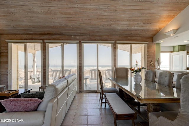 dining area with light tile patterned floors, wooden ceiling, and lofted ceiling