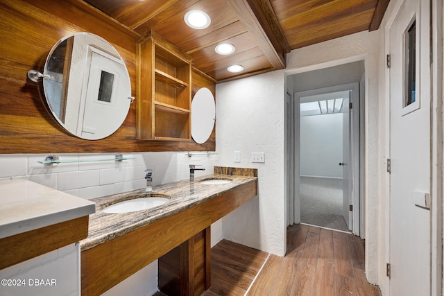 bathroom with wooden ceiling, beam ceiling, wood-type flooring, vanity, and decorative backsplash