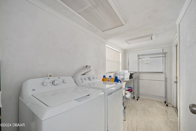 clothes washing area featuring washing machine and dryer