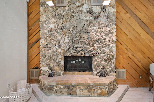 living room with wood walls and a fireplace