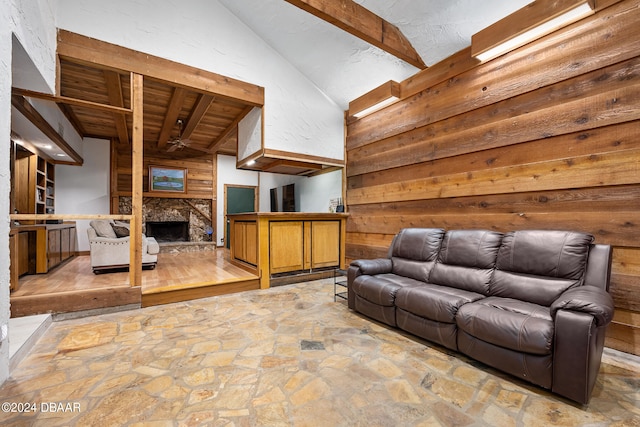 unfurnished living room featuring a fireplace and lofted ceiling with beams