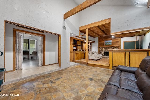 living room with vaulted ceiling with beams