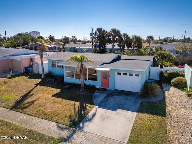 ranch-style house featuring a garage and a front yard