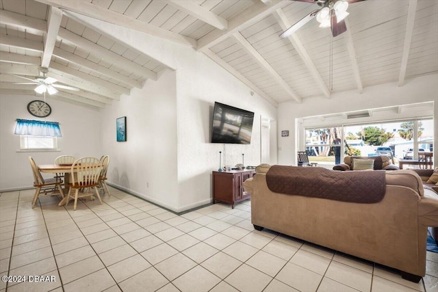 living room featuring ceiling fan, beamed ceiling, light tile patterned floors, and high vaulted ceiling