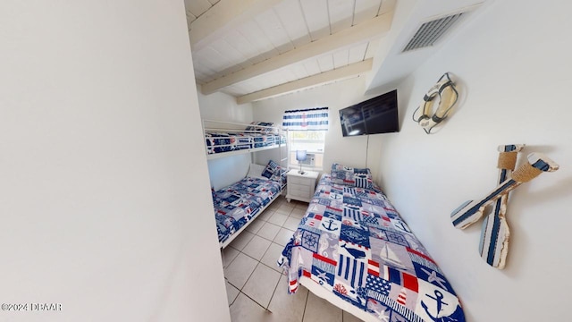 tiled bedroom featuring beam ceiling and wooden ceiling