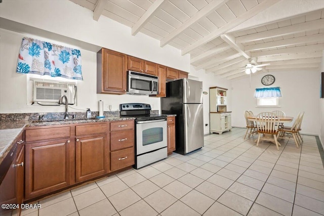 kitchen with ceiling fan, sink, stainless steel appliances, vaulted ceiling with beams, and light tile patterned floors