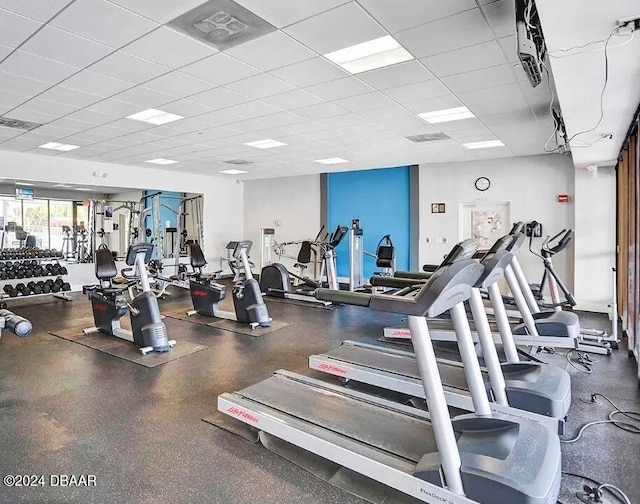 gym with a paneled ceiling