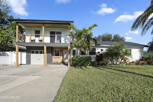 modern home with a garage, a balcony, and a front yard