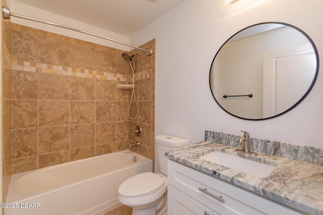 full bathroom with vanity, toilet, and tiled shower / bath