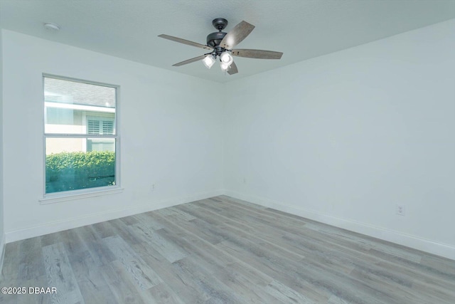 spare room featuring ceiling fan and light wood-type flooring