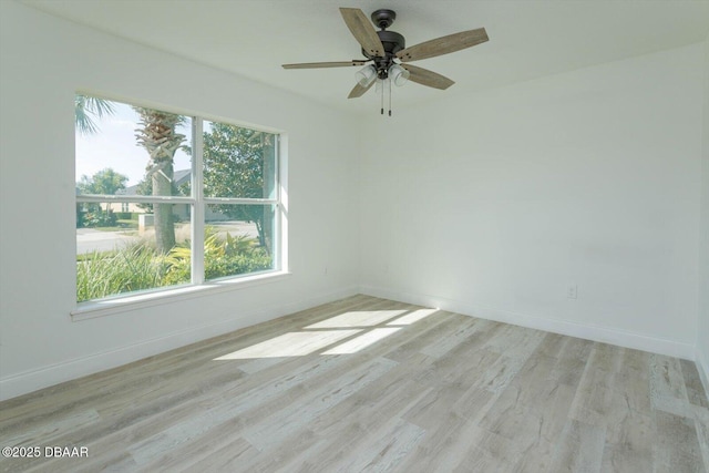 empty room with ceiling fan, light hardwood / wood-style floors, and a wealth of natural light