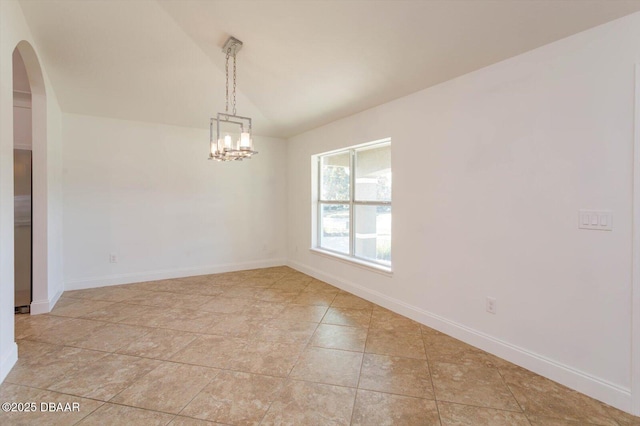 spare room with an inviting chandelier and vaulted ceiling