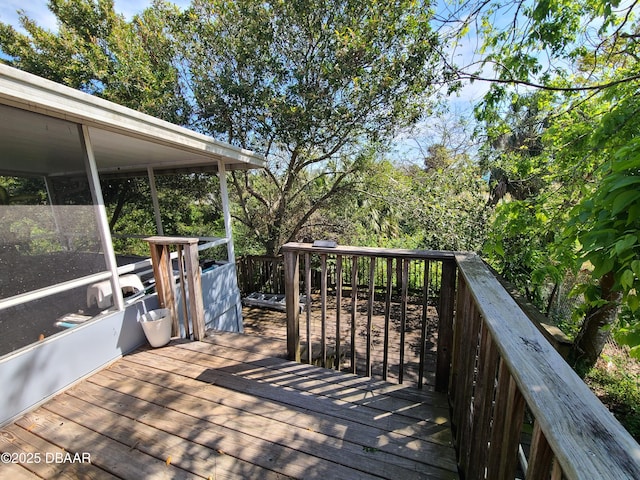 wooden deck with a sunroom