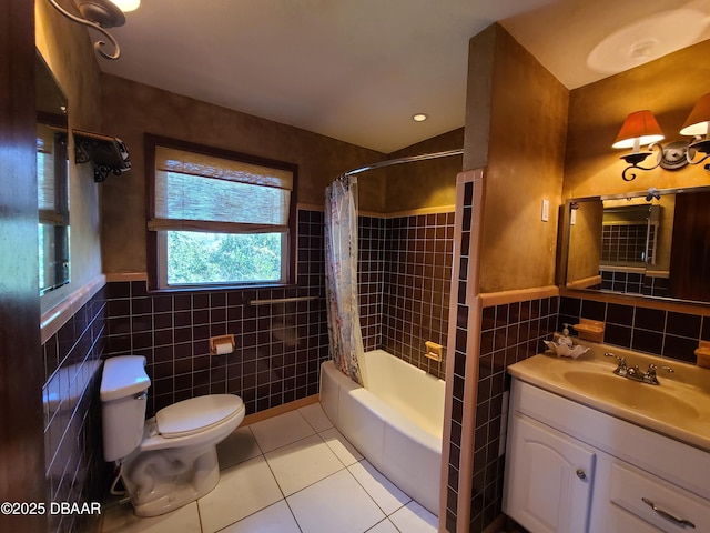 bathroom with tile patterned floors, toilet, tile walls, and vanity