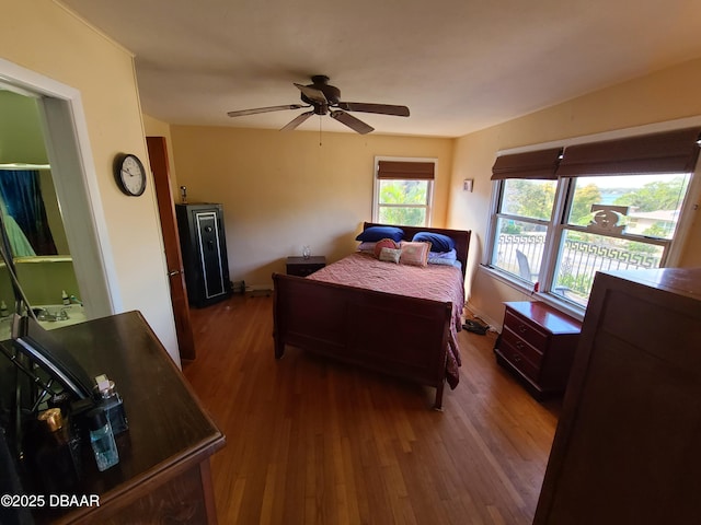 bedroom with wood finished floors, baseboards, and ceiling fan