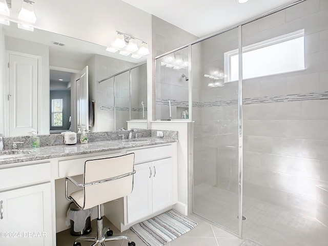 bathroom with tile patterned flooring, vanity, and an enclosed shower