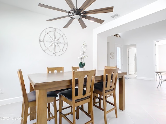 tiled dining room featuring ceiling fan