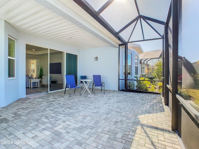 sunroom featuring beamed ceiling