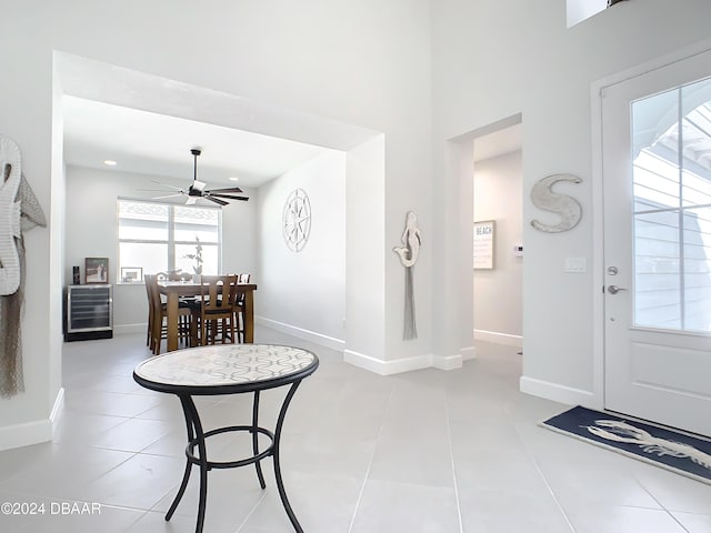 tiled entryway featuring ceiling fan and wine cooler