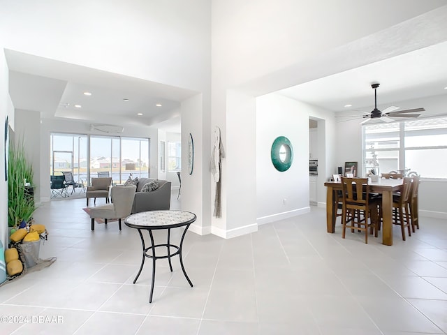 dining space with ceiling fan and light tile patterned flooring