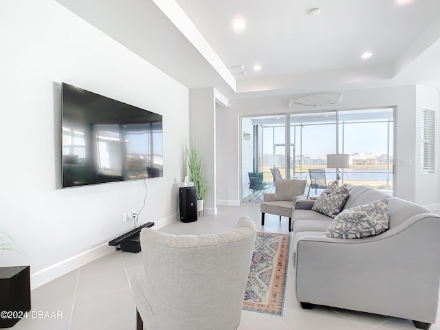 tiled living room with a tray ceiling