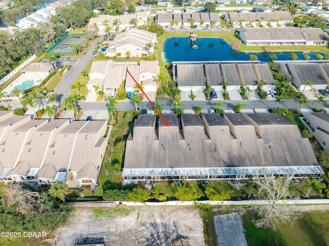 drone / aerial view featuring a residential view and a water view