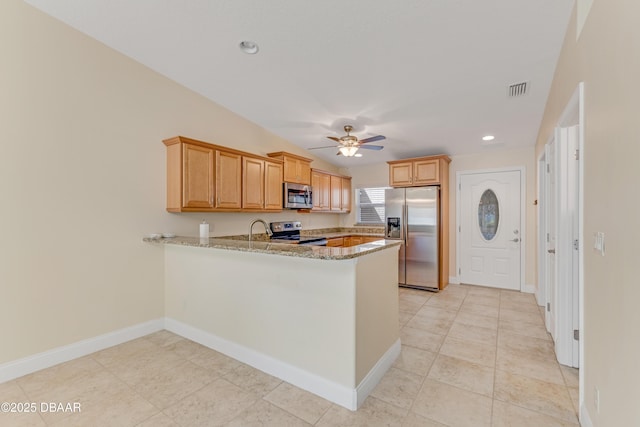 kitchen with visible vents, light stone countertops, a peninsula, stainless steel appliances, and a ceiling fan