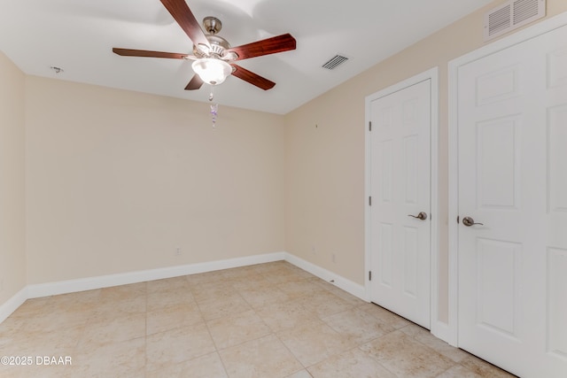 unfurnished bedroom with a ceiling fan, baseboards, and visible vents