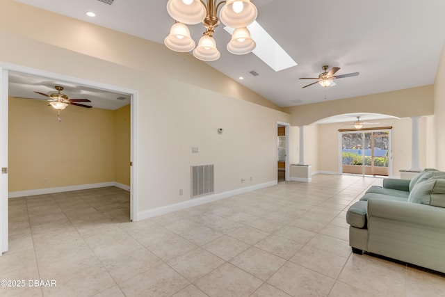 unfurnished living room with lofted ceiling with skylight, a ceiling fan, visible vents, and ornate columns