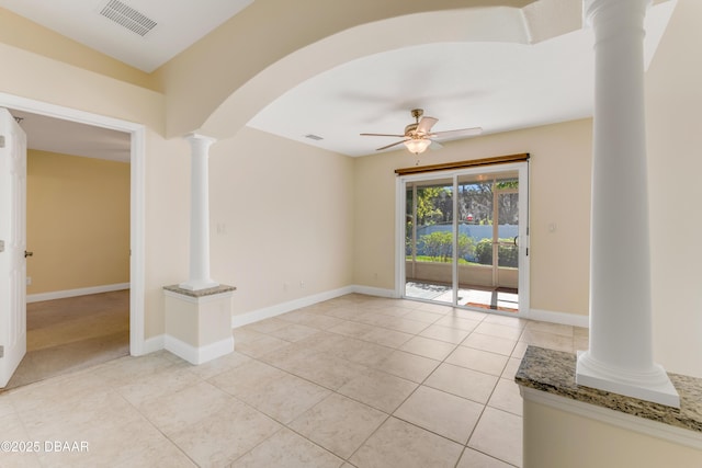 empty room featuring visible vents, baseboards, decorative columns, arched walkways, and a ceiling fan