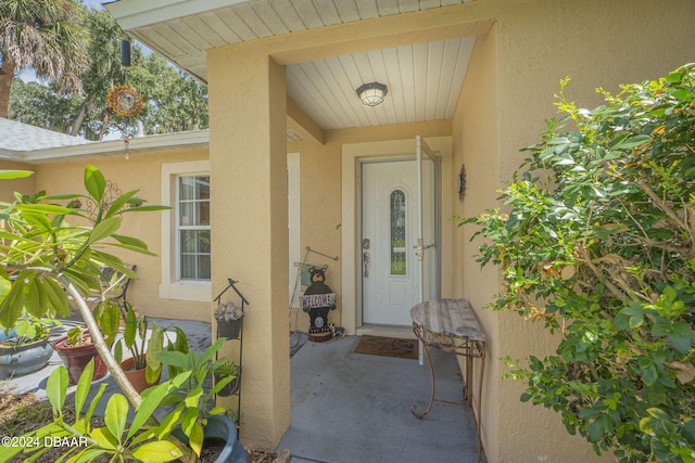 property entrance featuring a patio