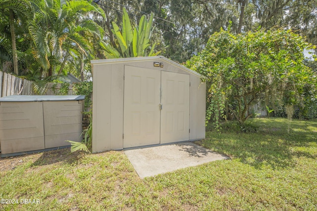 view of outbuilding with a lawn