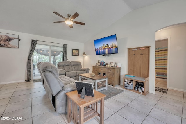 living room featuring ceiling fan, light tile patterned flooring, and vaulted ceiling