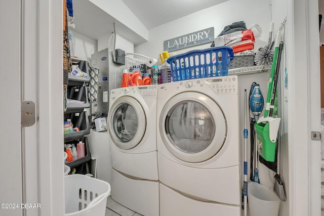 washroom with tile patterned flooring, washing machine and dryer, and a textured ceiling