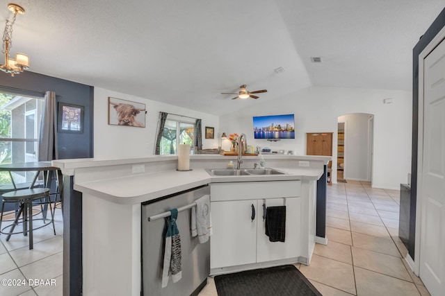 kitchen with stainless steel dishwasher, decorative light fixtures, light tile patterned flooring, and white cabinetry