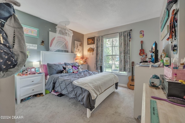 carpeted bedroom with a textured ceiling