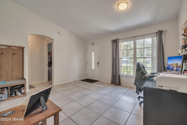 office area with light tile patterned floors and a textured ceiling