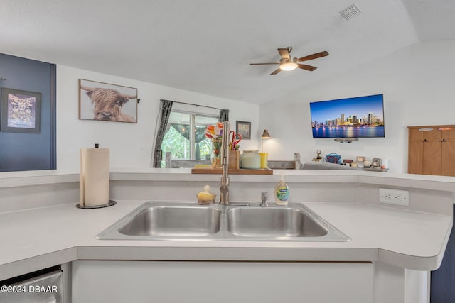 kitchen with dishwashing machine, sink, ceiling fan, and vaulted ceiling