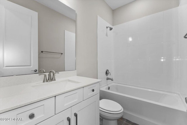 full bathroom with tiled shower / bath, vanity, and toilet