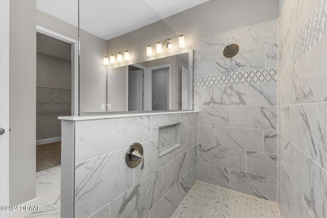 bathroom featuring a tile shower