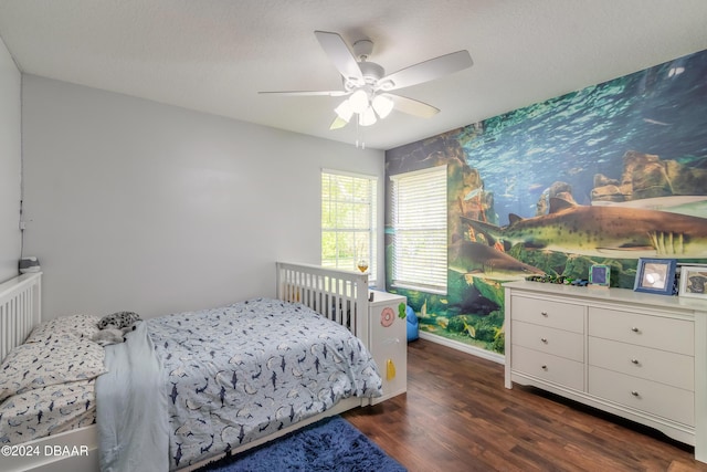 bedroom with wood finished floors, baseboards, and a ceiling fan