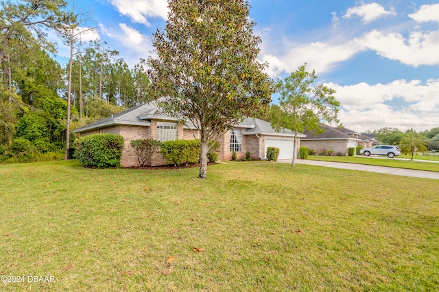 single story home featuring a garage and a front yard