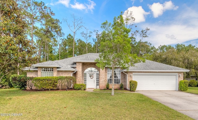 view of front of property featuring a garage, concrete driveway, a front lawn, and brick siding