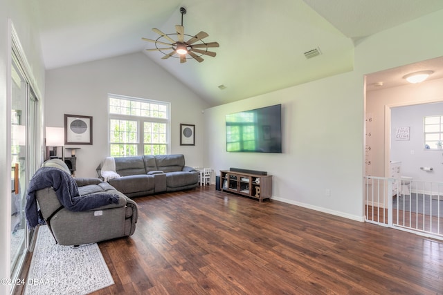 living room featuring dark hardwood / wood-style flooring, ceiling fan, high vaulted ceiling, and a healthy amount of sunlight